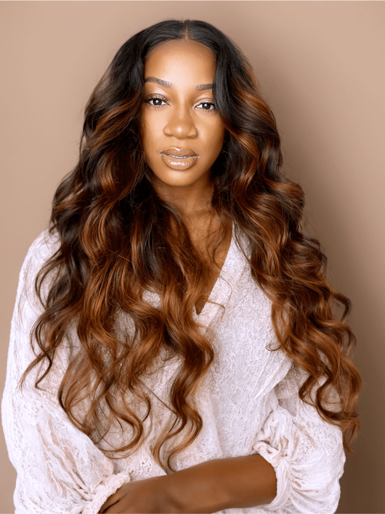 A model displays the UNice Balayage Ombre Highlight Body Wave 4x4 Free Part Lace Closure 1 Piece, showing a model with long brown hair and a white shirt and body wave.