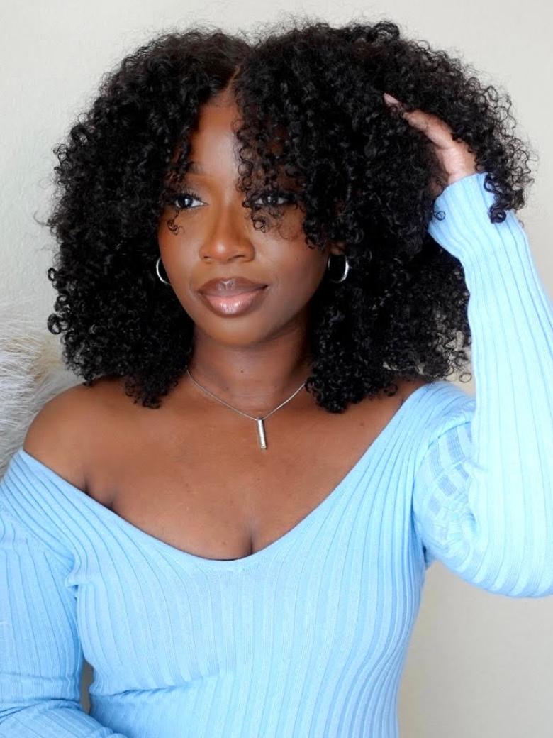 A model displays the UNice Hot Lace Part Wig Breathable Kinky Curly wig Natural Hairline, showing a model with curly hair wearing a blue sweater and kinky curly texture.