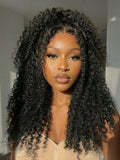 A model displays the UNice Invisi Drawstring 22" Bye Bye Knots 7x5 Lace Black Fluffy Kinky Coils Texture Wig, showing a model with long curly hair wearing a tan colored.