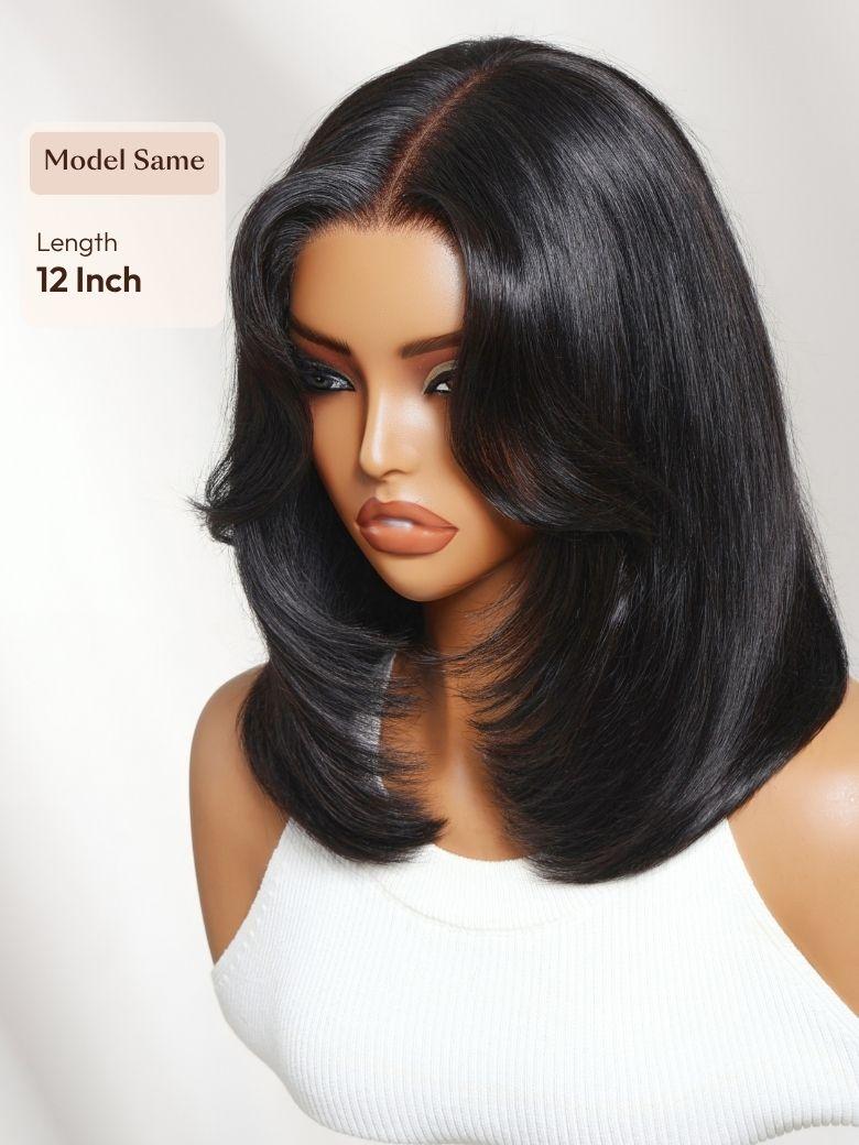 A model displays the UNice 7x5 Bye Bye Slip Lace Black Blowout Layered Bob Wig with Curtain Bang, showing a model with long black hair wearing a wig and 7x5, lace finish.