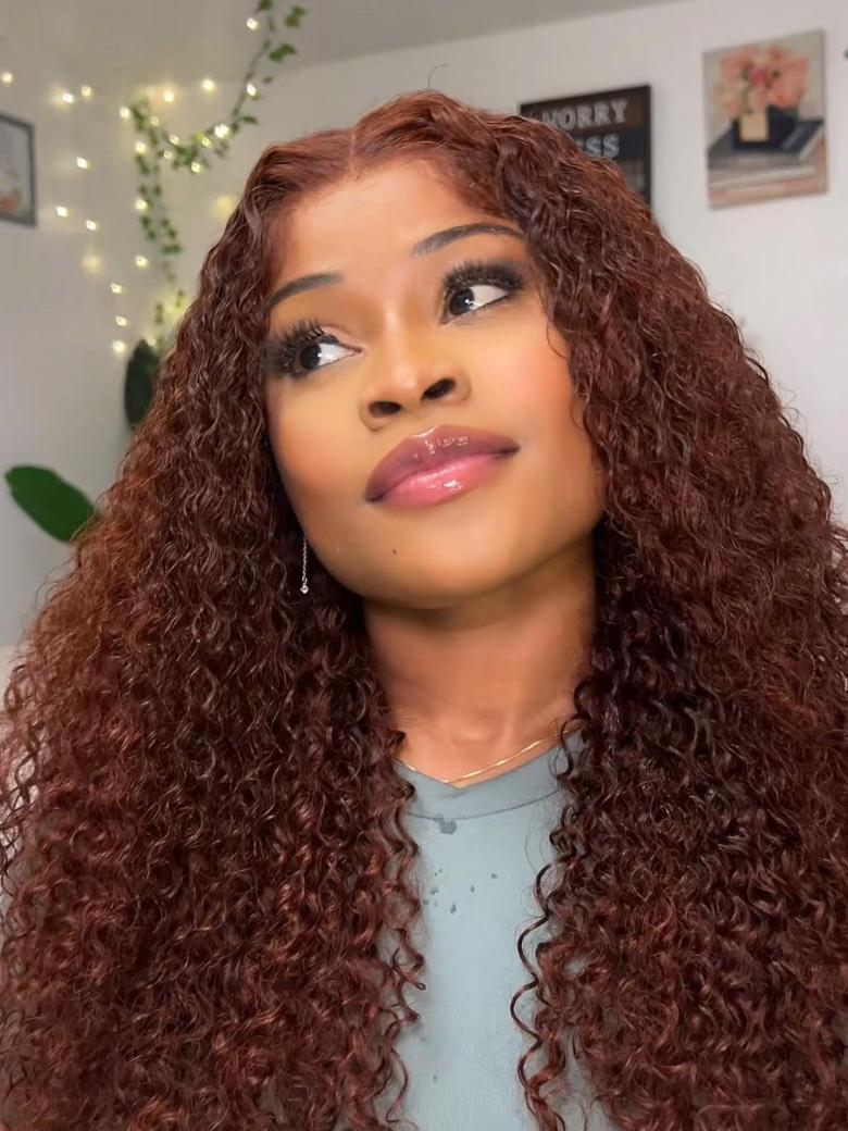 A model displays the UNice 13x4/7x5 Glueless Lace Bye Bye Knots Wig Reddish Brown Curly Wig With Bleached, showing a model with long curly hair and a blue shirt.