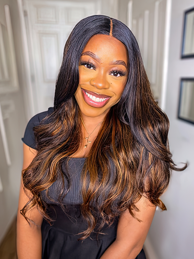 A model displays the UNice Balayage Ombre Highlight Body Wave 4x4 Free Part Lace Closure 1 Piece, showing a model with long hair and a black dress and body wave texture.